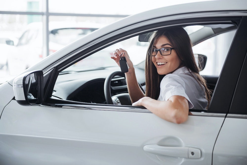 15 Car Dealership BDC Email Templates 1 image of woman holding keys in her new car