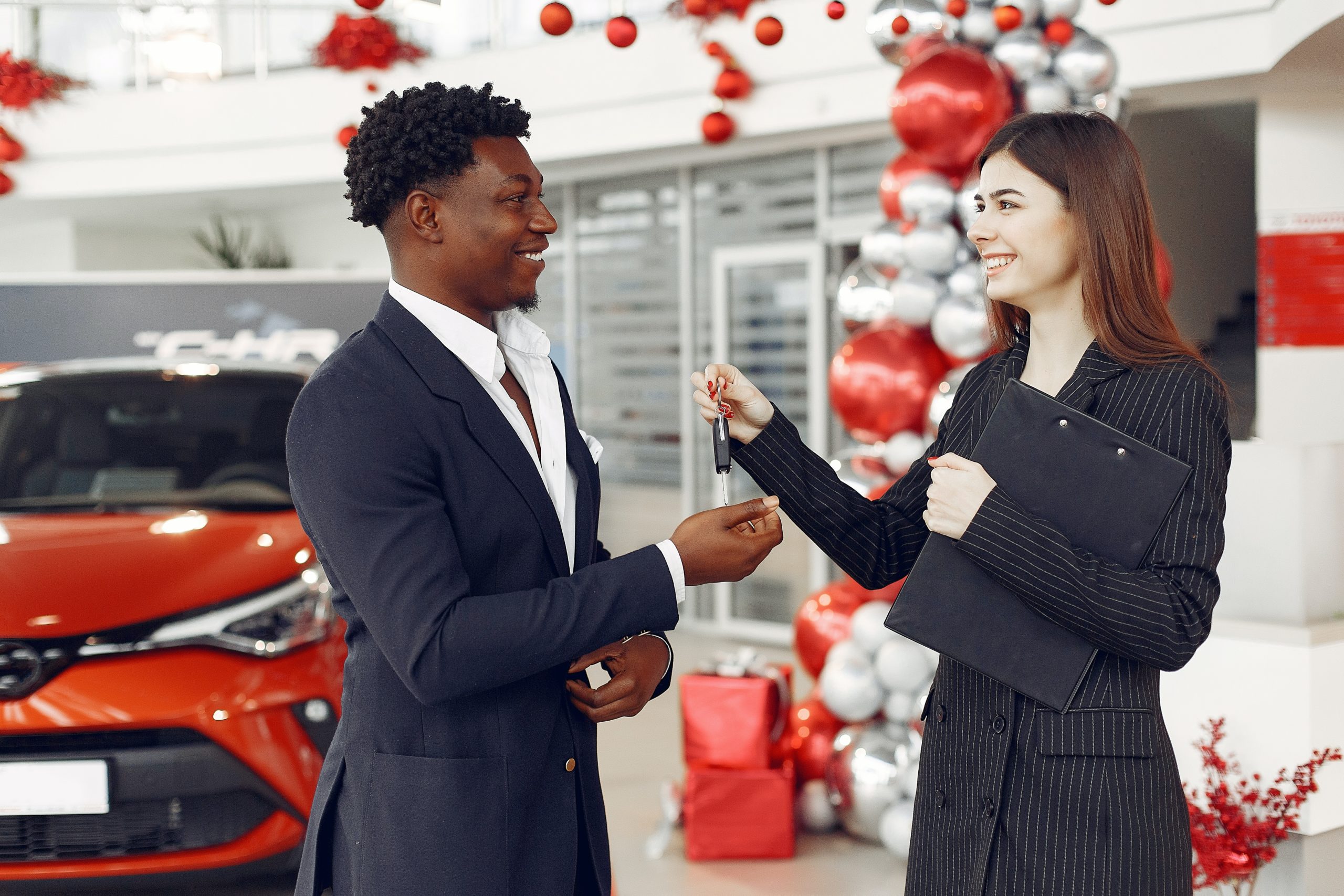 9 Challenges Affecting Car Dealerships And How Implementing CRM Software Can Help You In Overcoming Them 2 Car Saleswoman Handing over Car Keys